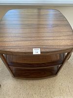 Top view of the brown walnut wood end table showing smooth top surface and rounded corners.