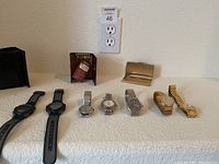 Front view of all watches and wallets, showing variety of styles and materials