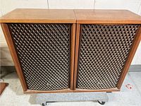 Pair of Sansui SP-1700 speakers showing front view with diamond patterned grills and wood veneer tops.