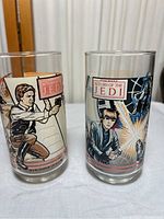 Two vintage Star Wars Return of the Jedi Coca-Cola glasses from Burger King showing front artwork.