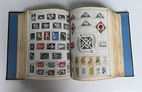 Open view of album pages showing a mix of rectangular and triangular stamps including thematic and commemorative designs.