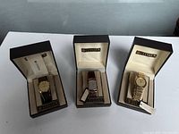 Three watches in original Citizen boxes: two round watches and one rectangular watch