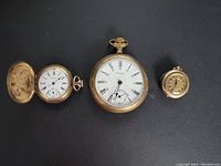 Three Waltham pocket watches side by side on black background showing size comparison and overall condition.