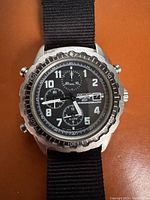 Front view of vintage Seiko 200 chronograph watch with black dial showing time, date, and chronograph subdials.