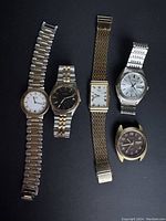 Full view of all five vintage Seiko watches arranged horizontally, showing different dial styles, bands, and missing components