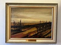 Full view of the framed painting "Cote Nord" with visible landscape and modest frame.