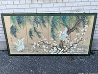 Full view of the four-panel figure screen showing hand-painted cranes, blossoming branches, and naturalistic leaves on silk with a dark wood frame lying flat.