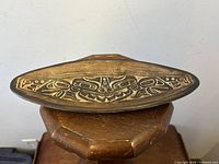 Top view of the elongated ovoid shaped tray showing the detailed incised sea monster design in Haida style.