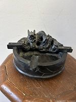 Top and side views of vintage blackstone ashtray with carved dragon figure showing details and condition.