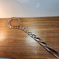 Top-down view of loop handle and twisted shaft on wooden surface