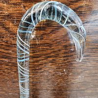 Close-up of the curved gooseneck handle showing white swirl ribbon pattern