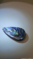 Front view of pear-shaped abalone doublet gemstone showing vibrant natural color and patterns.