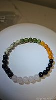 Front view of the natural mixed gemstone bracelet laid flat showing bead colors and layout