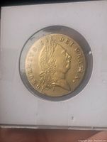 Obverse side of the 1768 George III gold coin showing King George III profile with laurel wreath and inscription.