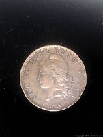 Front side of 1889 Dos Centavos coin showing the profile of a woman with inscriptions 'LIBERTAD' and 'DOS CENTAVOS'