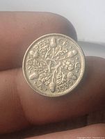 Reverse side of the 1935 England Silver 6 Pence coin featuring denomination and floral design.