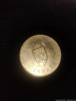 Obverse side of medallion showing crowned shield crest and 'CANADA' text.