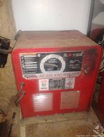 Front view of the Lincoln Electric AC 225 Arc Welder showing control dial, warning labels, power switch, and cables