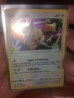 Front view of Eevee holographic foil Pokémon card showing illustration and stats.