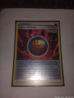 Photo of front side of Single Strike Fighting Energy Pokemon card showing detailed artwork and text.