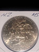 Reverse side of the coin featuring the British Commonwealth Games emblem with various athletic figures in motion around a geometric center.