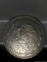 Obverse side of Mexico 20 Peso Coin showing the eagle with snake emblem and inscription around the edge.