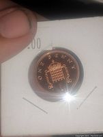 Reverse side of the UK One Penny proof coin showing the crowned portcullis and denomination.
