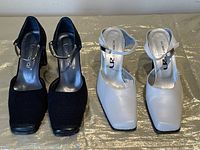 Photo of two pairs of women's dress slingback shoes, black and white, size 35, showing top view.