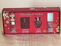 Front view of unopened Elizabeth Arden perfume gift set box showing three perfume bottles through window.