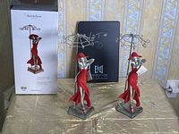 Two Clair de Lune lady in red jewelry holders on display with one in original box