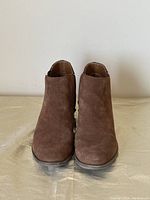 Front view of the brown suede Kensie boots showing rounded toes and overall shape.