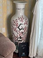Front view of full-height porcelain vase next to furniture