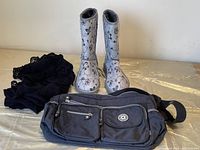 Overview photo of brown nylon purse, black scarf, and brown YDGG boots with floral pattern
