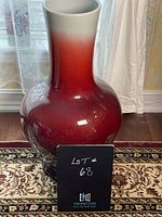 Full view of tall ombre red ceramic vase from front showing gradient color and shape