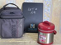Gray insulated lunch bag with Roots logo and red-top stainless steel soup thermos on a table