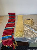 Photo showing two scarves and a small purse on a table