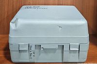 Closed gray plastic carrying case with label indicating 18V saw and drill.