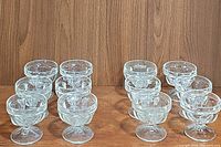 Front view of 20 clear glass parfait cups arranged in groups.