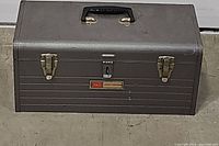 Closed metal Craftsman toolbox with handle and two latches on front.