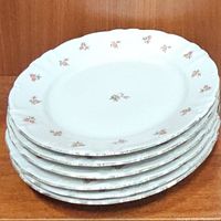 Stack of 5 dinner plates showing the rose bud floral pattern on white china with scalloped edges.