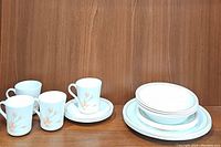 Overall photo showing 4 coffee mugs, 4 saucers, 4 dinner plates, and 4 bowls in vintage Corelle CorningWare peach floral pattern.