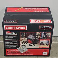 Front of the box showing Craftsman branding, product name, and images of the vacuum with accessories in use.