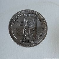 Obverse side of the 1958 Canadian silver dollar coin with Pacific Coast indigenous art design and inscriptions.