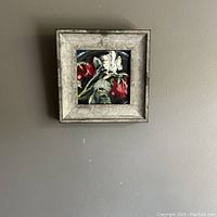 Frontal view of the framed original oil painting showing floral subject with red and white flowers, leaves and dark background.