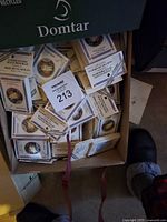 Open box filled with numerous trading cards in protective sleeves depicting Apollo mission patches.