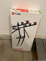 Photo of the boxed Allen Deluxe Trunk Bike Carrier showing front with product image and brand logo.