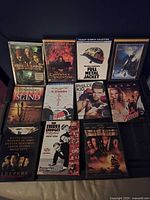 Front view of 12 Blu-ray and DVD movie cases arranged in three rows showing their cover art.