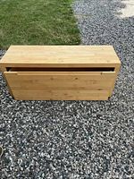 Top front view of the wooden hall bench showing lid and wood grain.