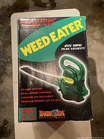 Box of Weed Eater Super Electric Blower/Vac EBV 215 showing product specifications and branding.