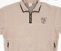 Close-up of front upper chest area showing embroidered Grumpy logo and zippered collar.